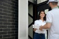 Woman receiving pizza from courier. Royalty Free Stock Photo