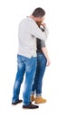 Back view of young embracing couple (man and woman) hug and look Royalty Free Stock Photo