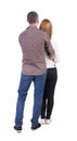 Back view of young embracing couple
