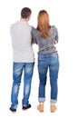 Back view of young embracing couple (man and woman) hug and look Royalty Free Stock Photo