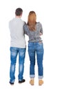 Back view of young embracing couple (man and woman) hug and look Royalty Free Stock Photo