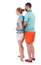 Back view of young embracing couple in shorts hug and look. Royalty Free Stock Photo