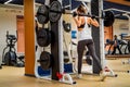 Back view of sporty woman doing squats on smith machine in gym Royalty Free Stock Photo
