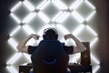 Back view of young gamer guy in headphones screaming and rejoicing unleash power while playing video games