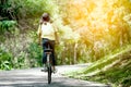 Back view of young girl riding bicycle in the garden Royalty Free Stock Photo