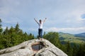 Young woman resting on a big stone in the summer day in the Carpathian mountains Royalty Free Stock Photo