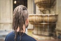 Back view of a young hipster man with dreadlocks and sidecut look at luxury restaurant