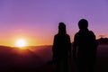 Young hipster photographer holding the camera with sunset on mountain natural background