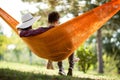 Back view of young man and girl in hammock Royalty Free Stock Photo