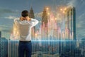 Back view of man looking at creative growing forex chart on blurry city background. Trade, finance and stock concept Royalty Free Stock Photo