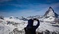 Tourist young man  taking pictures by smartphone at Matterhorn view in Zermatt, Switzerland Royalty Free Stock Photo