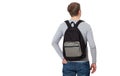 Back view. Young man wearing blank long sleeve t-shirt and backpack isolated on white background. Copy space. Student Royalty Free Stock Photo