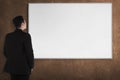Back view young man with white board Royalty Free Stock Photo