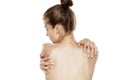 Back view of young nude woman, holding her shoulders Royalty Free Stock Photo