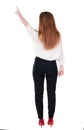 Back view of young redhead business woman pointing at wal Royalty Free Stock Photo