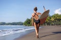 back view of young surfer walking with surfboard Royalty Free Stock Photo