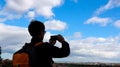 Back view Young tourist man hand which take a picture by Photo camera of a smartphone with blue sky scene in the city in Toledo Royalty Free Stock Photo
