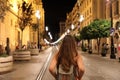 Back view of young tourist woman walking in Seville street in th Royalty Free Stock Photo