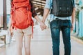 Back view of young traveler couple with backpack holding hand at train station Royalty Free Stock Photo