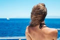 Back view of the young woman in bikini enjoying a boat ride Royalty Free Stock Photo