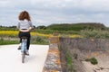 Back view young woman cycling at seaside on island Ile de Re in west France