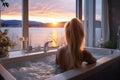 Young woman enjoying the sunset in a bathtub with soap bubbles in a Scandinavian style bathroom in an accommodation or SPA Royalty Free Stock Photo