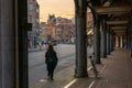 Back view of young woman going along amsterdam street