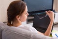 Back view of of young woman holding glasses while working on a l Royalty Free Stock Photo