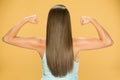 Back view of young woman with long hair, showing her hands Royalty Free Stock Photo