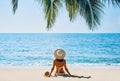 Back view of young woman relax alone on tropical beach Royalty Free Stock Photo