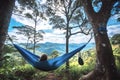Back view of Young Woman relaxing blue hammock looking out at lake. National natural park with beautiful landscape. Eco Royalty Free Stock Photo