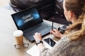 Back view. Young woman sitting in office working on laptop with inscription on monitor- cloud library. Business education