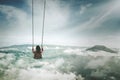Young woman with swing above misty city Royalty Free Stock Photo