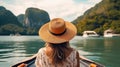 Back view of the young woman in straw hat relaxing on the boat and looking forward into lagoon. Travelling tour in Asia: El Nido, Royalty Free Stock Photo