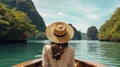 Back view of the young woman in straw hat relaxing on the boat and looking forward into lagoon. Travelling tour in Asia: El Nido, Royalty Free Stock Photo