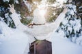 back view of young woman at sunset in snowy mountain with arms raised. Nature and fun concept. winter season Royalty Free Stock Photo