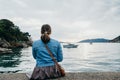 Back view of young Woman is taking pictures of the sunset on th Royalty Free Stock Photo