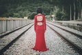 Back view of young woman on the train tracks Royalty Free Stock Photo