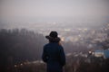 Back view of woman in hat standing on hill of autumn park Royalty Free Stock Photo