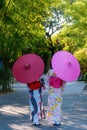 Back view of a young woman wearing a Japanese Yukata and holding a paper umbrella