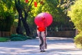 Back view of a young woman wearing a Japanese Yukata and holding a paper umbrella