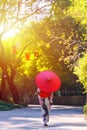 Back view of a young woman wearing a Japanese Yukata and holding a paper umbrella