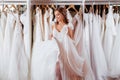 Back view of a young woman in wedding dress looking at bridal gowns Royalty Free Stock Photo