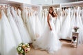 Back view of a young woman in wedding dress looking at bridal gowns Royalty Free Stock Photo