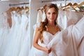 Back view of a young woman in wedding dress looking at bridal gowns Royalty Free Stock Photo