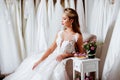 Back view of a young woman in wedding dress looking at bridal gowns Royalty Free Stock Photo