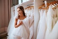 Back view of a young woman in wedding dress looking at bridal gowns Royalty Free Stock Photo