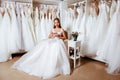 Back view of a young woman in wedding dress looking at bridal gowns Royalty Free Stock Photo