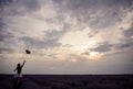 Back view of a young woman in white dress and straw hat walking in the lavender field Royalty Free Stock Photo