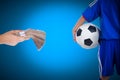 Back view of youth soccer player and hand holding stacks of bank Royalty Free Stock Photo